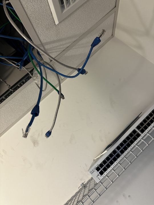 Low-voltage cabling run across the warehouse ceiling.