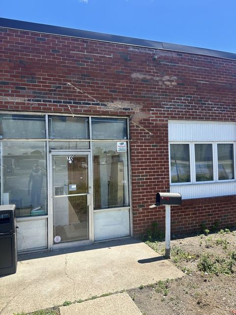 Warehouse front elevation after lintel replacement and masonry repair