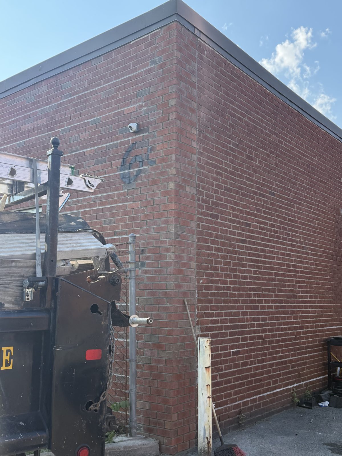 Rebuilt brick corner of an industrial building in Hicksville after masonry repair