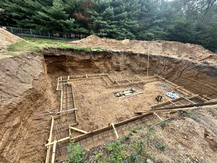 Footing forms laid out in the excavation.