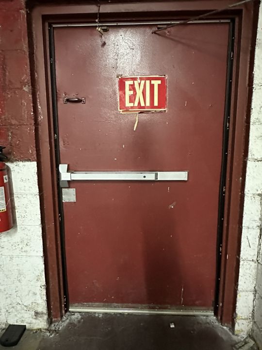 Door re-hung with new panic hardware and sweep.