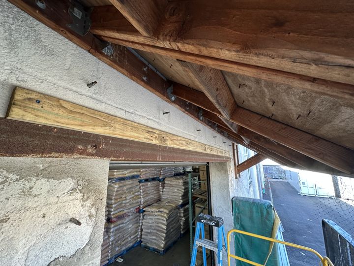 Dock canopy framing repaired before netting.