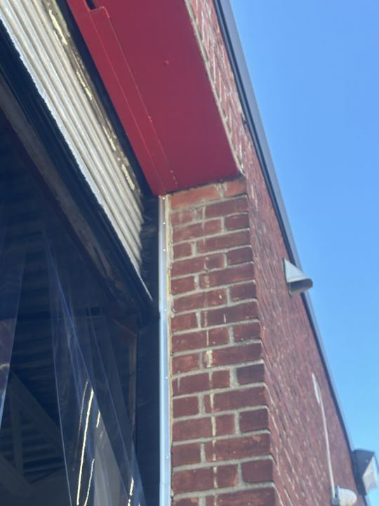Brick jamb sealed at an exterior door.