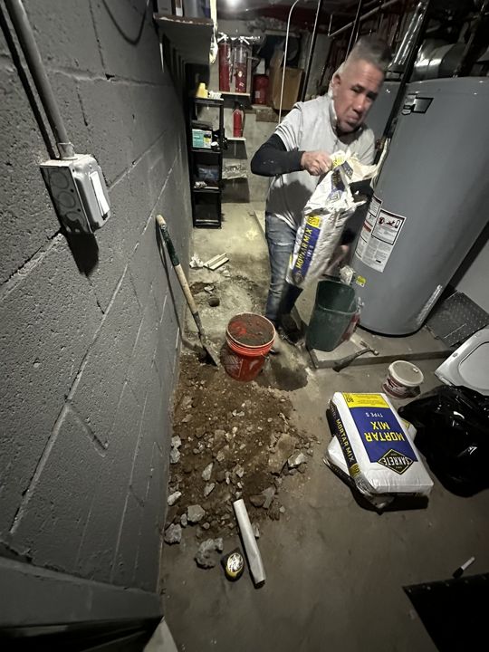 Basement floor-drain repair in progress.