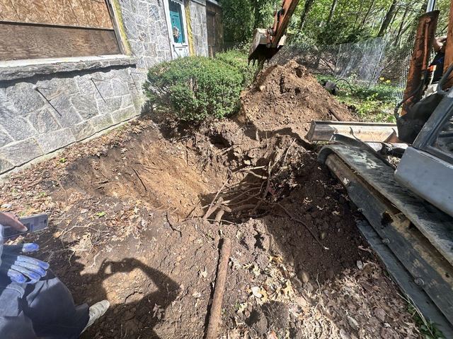 Excavation to expose an underground oil tank at a Woodbury residential site