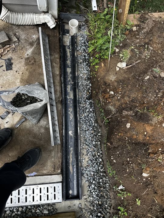 Trench-drain grate at the slab edge.
