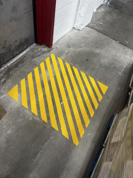 Hazard striping at a doorway.